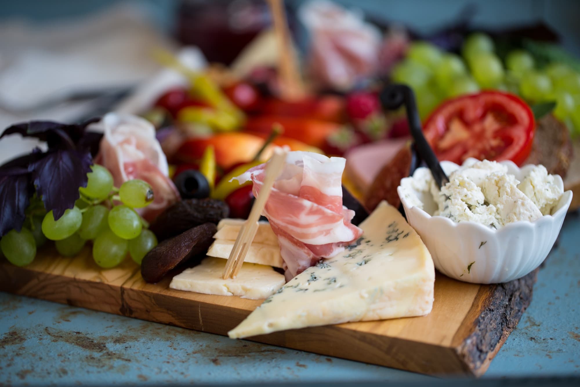 A grazing board of artisan cheeses, cured meats and fresh fruit